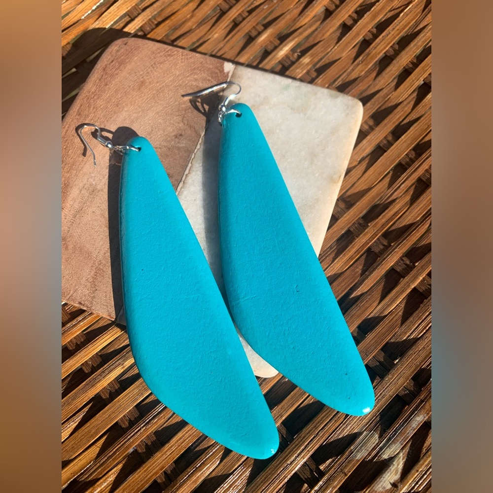 Handmade bohemian earrings made of wood and painted turquoise.